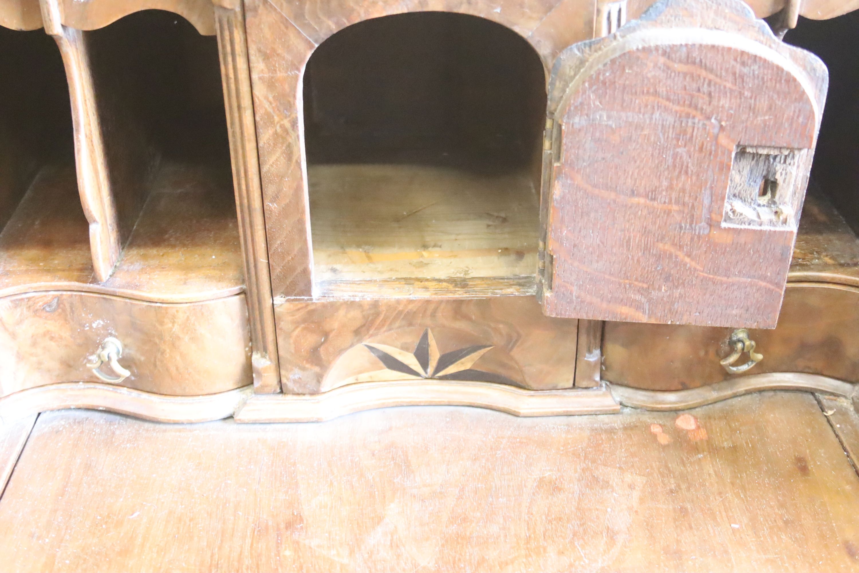 A Queen Anne style walnut double domed top bureau bookcase, length 72cm, width 50cm, height 196cm